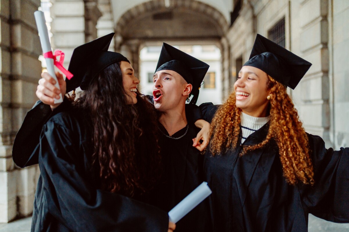 Happy students celebrating graduation day at university